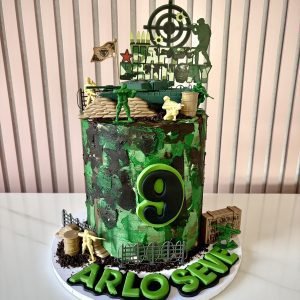 Army themed birthday cake with camouflage buttercream, tank, soldiers and battlefield decorations