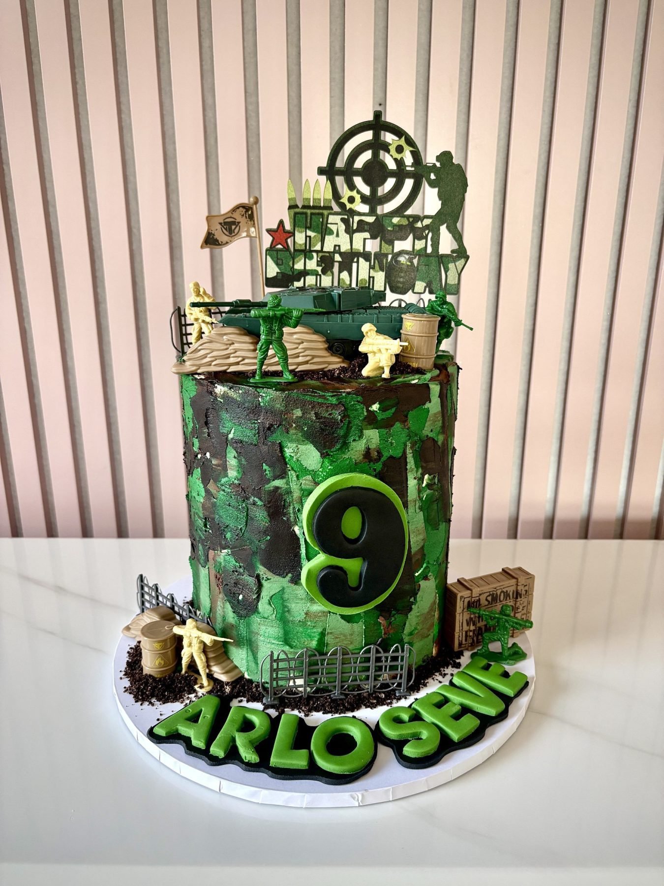 Army themed birthday cake with camouflage buttercream, tank, soldiers and battlefield decorations