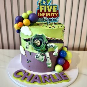 Buzz Lightyear themed birthday cake with green and purple buttercream, character decoration and colourful details