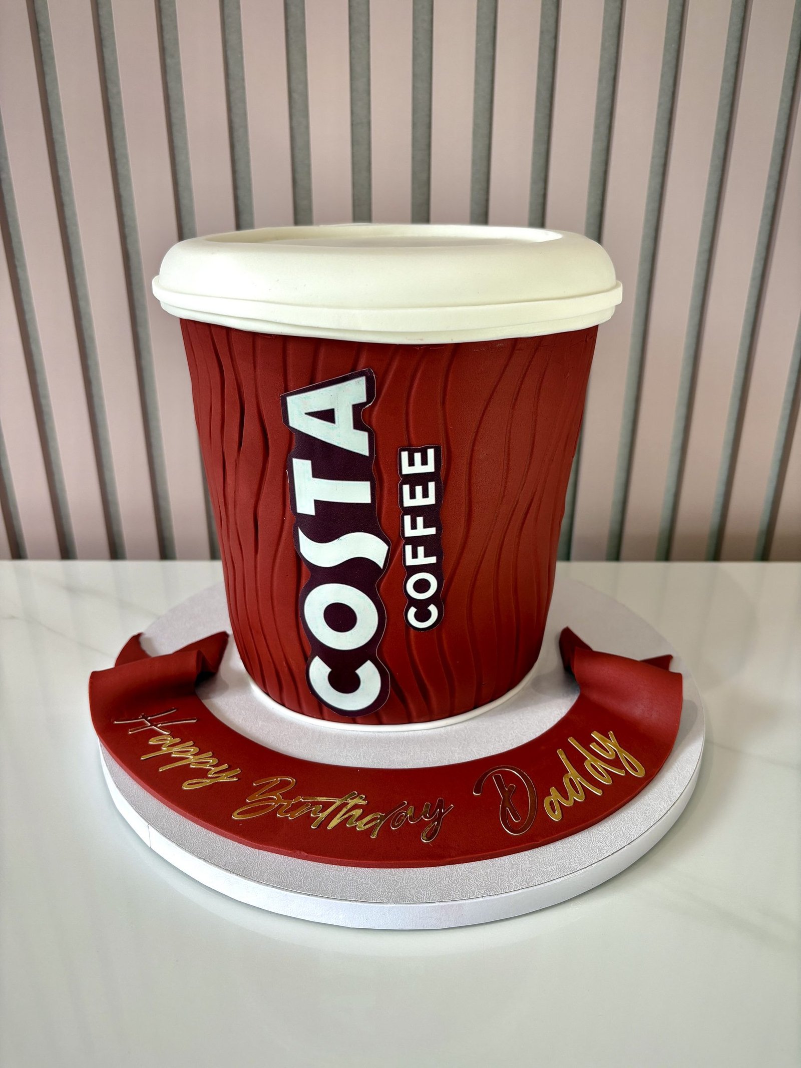 Costa coffee cup themed birthday cake designed as a realistic red takeaway coffee cup