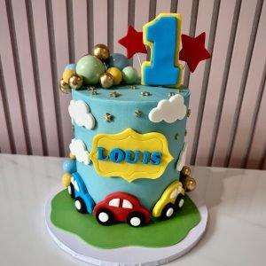 colourful car themed birthday cake with fondant vehicle details and bright decorations