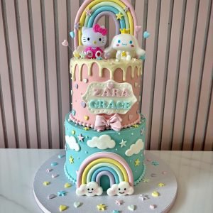 Hello Kitty two tier birthday cake with pastel rainbow design, clouds, stars and personalised name on front
