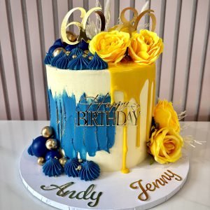 Half and half birthday cake with blue buttercream texture and yellow drip design for a joint celebration