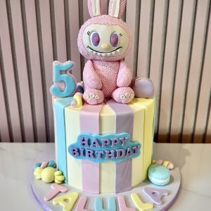 Labubu themed birthday cake with pastel buttercream, bunny character topper and colourful sweet decorations