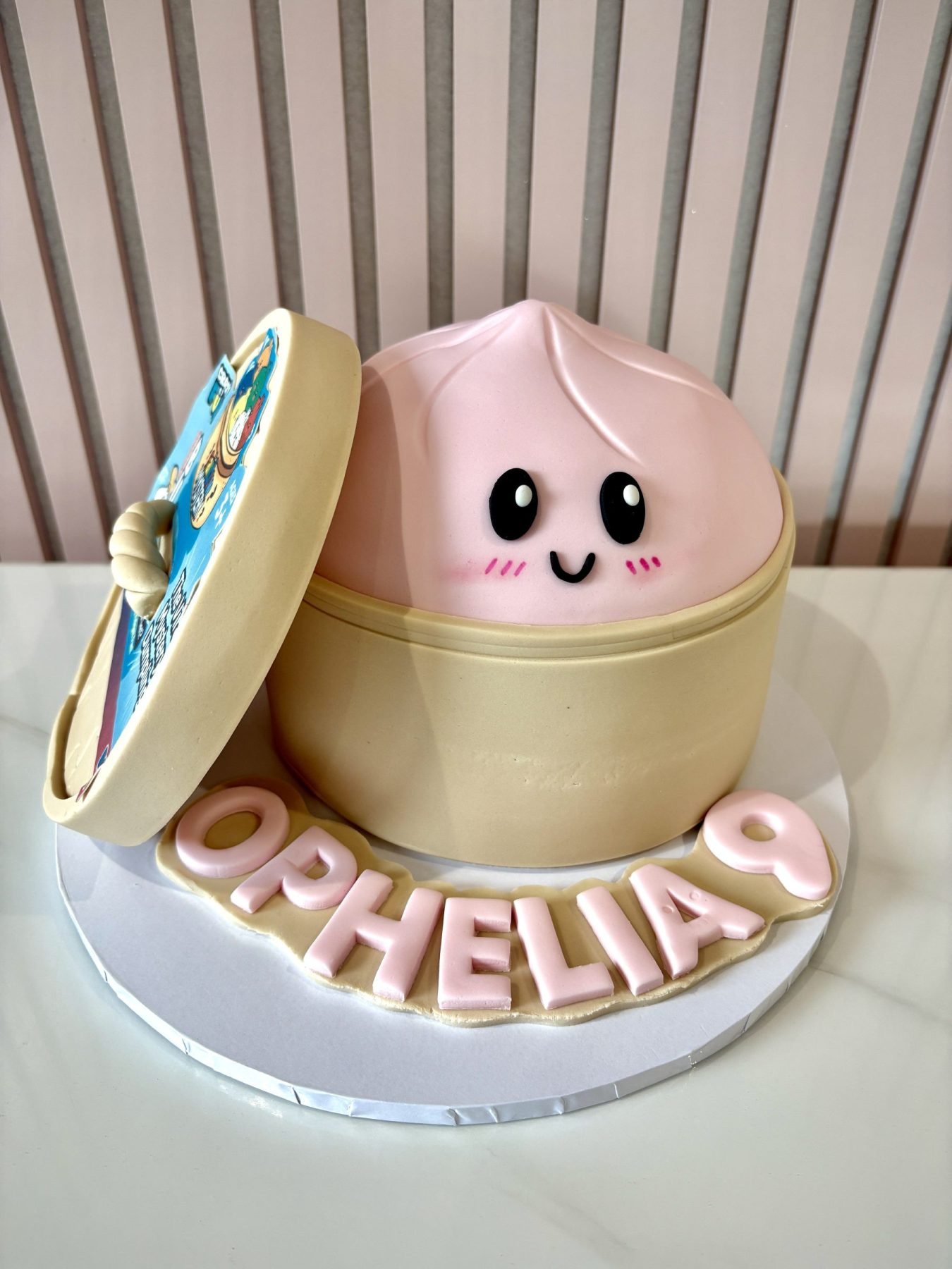 Mystery dumpling birthday cake with fondant dim sum steamer design and cute character inside with personalised name