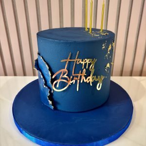 Modern navy blue birthday cake with gold accents, textured tear detail and elegant finish for men