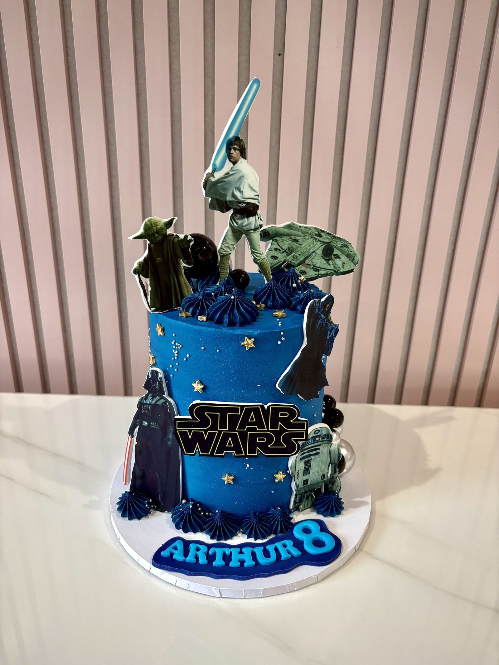 Star Wars themed birthday cake with galaxy design, character toppers and blue space background