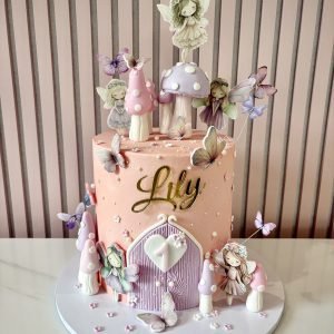 Enchanted fairy birthday cake with fondant finish, butterflies, toadstools and woodland theme details