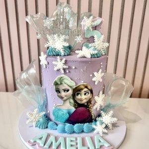 Frozen inspired birthday cake with Elsa and Anna decorations, snowflakes and ice-effect sugar sails