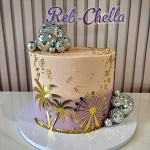 Ibiza sunset themed birthday cake with peach and lilac buttercream, gold palm trees and disco ball decorations
