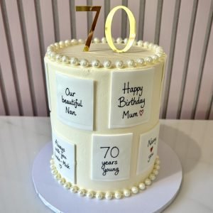 Elegant buttercream birthday cake with personalised message card details and pearl decoration