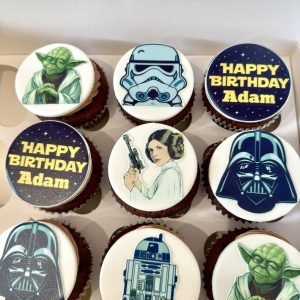 Star Wars themed cupcakes with edible toppers featuring Darth Vader, Yoda, Princess Leia, Stormtrooper and R2-D2 designs
