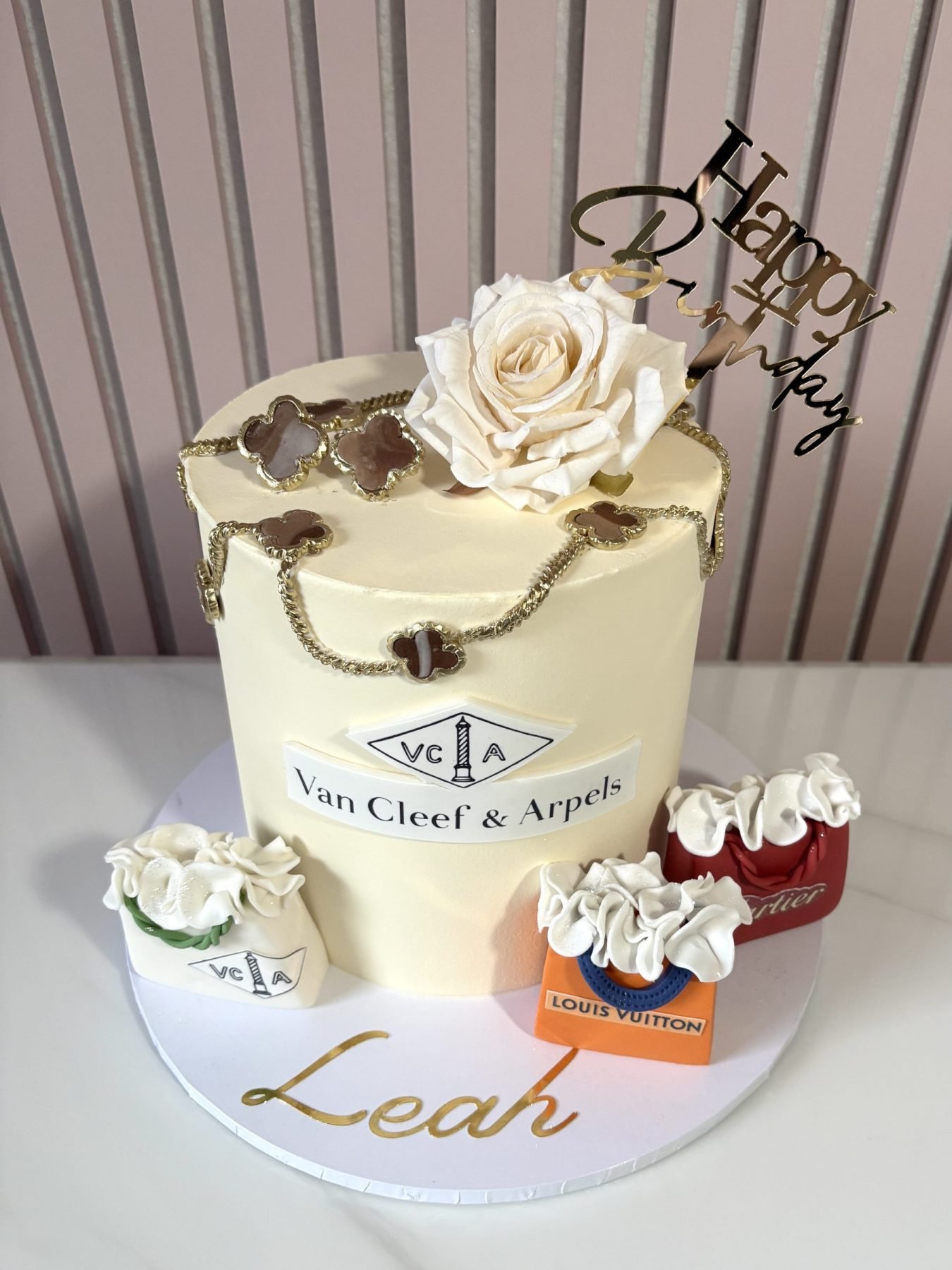 Luxury inspired buttercream birthday cake with handcrafted necklace and earring details and designer inspired decorations